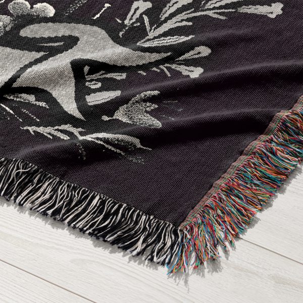 Close-up of Aquarius Flow woven blanket, showing skeleton hand with water and floral accents.