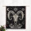 Aries Spirit woven blanket hung on wall as tapestry, featuring bold buffalo skull and floral details.