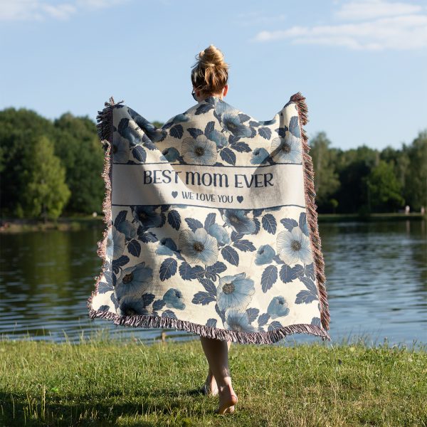 Woman with her back turned, wrapped in the "Best Mom Ever" blanket, showing its size and elegant floral pattern.