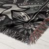 Close-up of Cancer Spirit woven blanket, showcasing crab and human skull with stars and flowers.