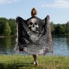 Woman wrapped in Cancer Spirit woven blanket, crab and skull design visible from behind.