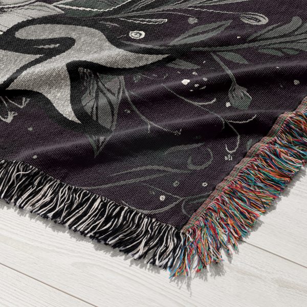 Close-up of Capricorn Resilience woven blanket, showing intricate goat skull and floral pattern.