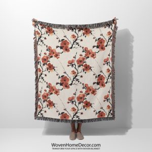 Japanese style woven blanket held by woman, featuring elegant patterns and soothing tones.