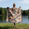 Woman wrapping herself in Japanese style woven blanket, back view, with vibrant patterns