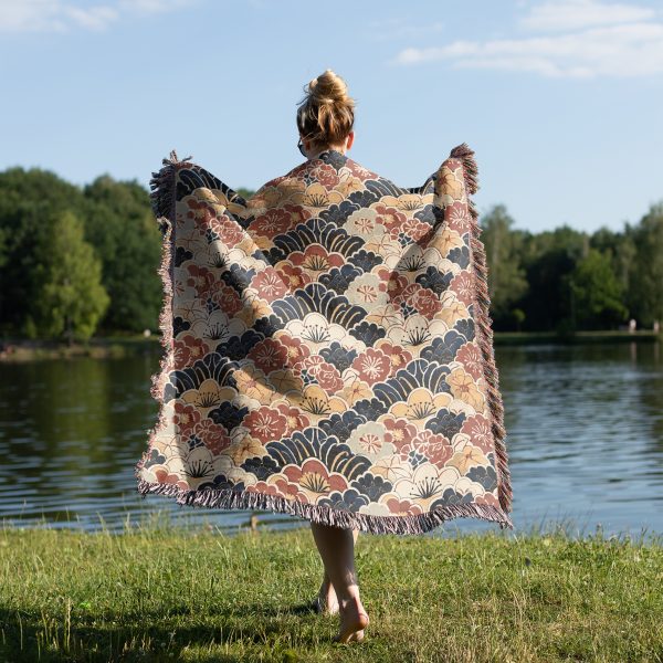 Woman wrapping herself in Japanese style woven blanket, back view, with vibrant patterns