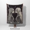 Woman holding the Gemini Duality woven blanket with twin skeletons; woman not visible.