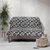 Japanese style woven blanket draped over sofa, adding warmth and simplicity to the living space.