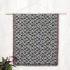 Japanese style woven blanket hanging on wall as tapestry, with minimalist and elegant design.