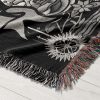 Close-up of Leo Majesty woven blanket, focusing on lion skull and floral details.