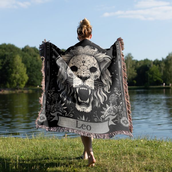 Woman wrapped in Leo Majesty woven blanket, lion skull design visible from behind.