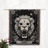 Leo Majesty woven blanket hung on wall as tapestry, showcasing lion skull and decorative floral patterns.