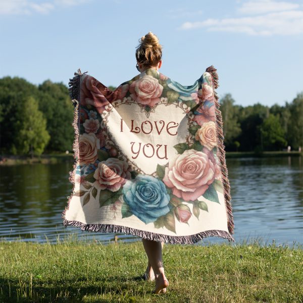 Woman with her back turned, wrapped in the "Love Blooms Woven Blanket," highlighting its romantic design and size.