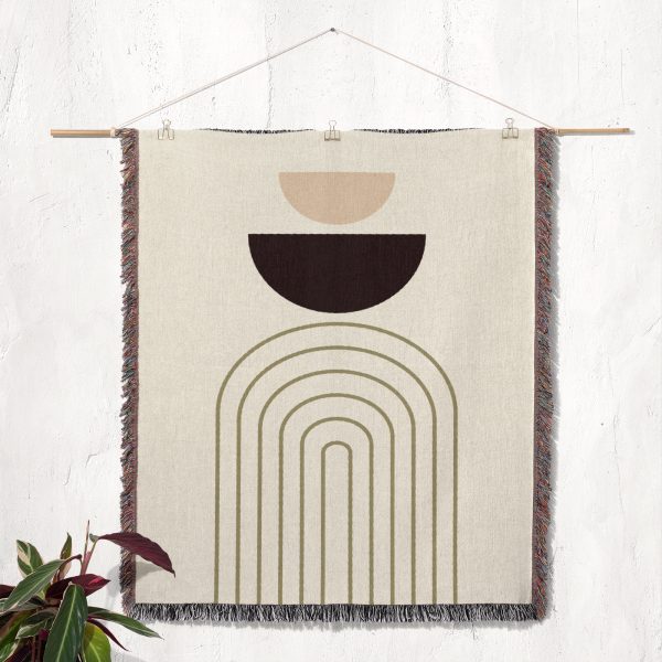 Modern Arc Woven Blanket hanging on the wall as a tapestry, showcasing its minimalist design.