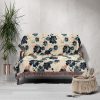 Ocean Bloom Woven Blanket draped over sofa, blue floral pattern adding elegance to home decor.