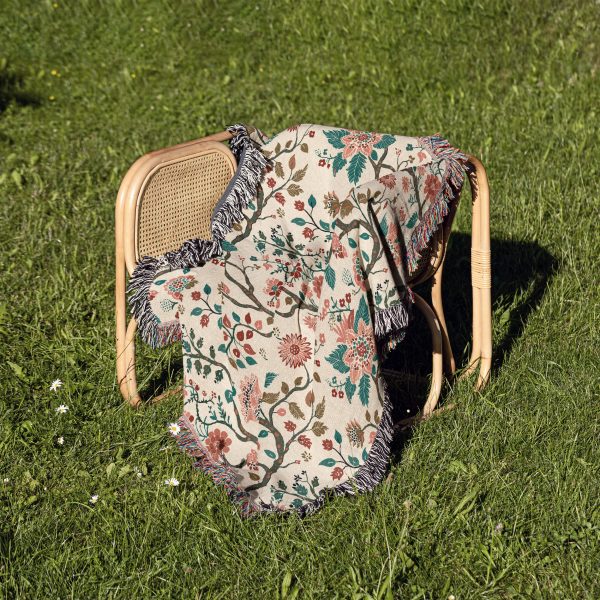 Pink-Blossom-Woven-Blanket-lies-on-chair