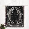 1. Pisces Dream woven blanket hung on wall as tapestry, showcasing twin fish skeletons with stars and flowers.