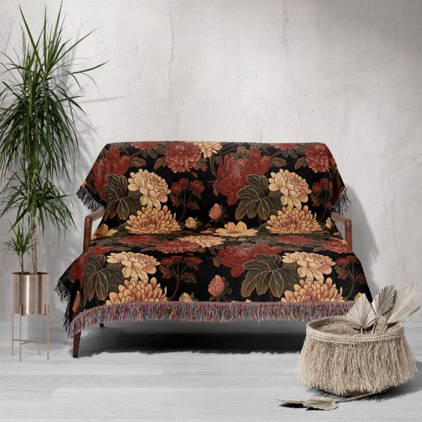 Floral woven blanket draped over couch, with large, bold flower patterns in vibrant colors adding a lively touch.