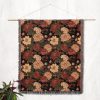 Floral woven blanket hanging on wall as tapestry, featuring large, bold flowers in vibrant colors.