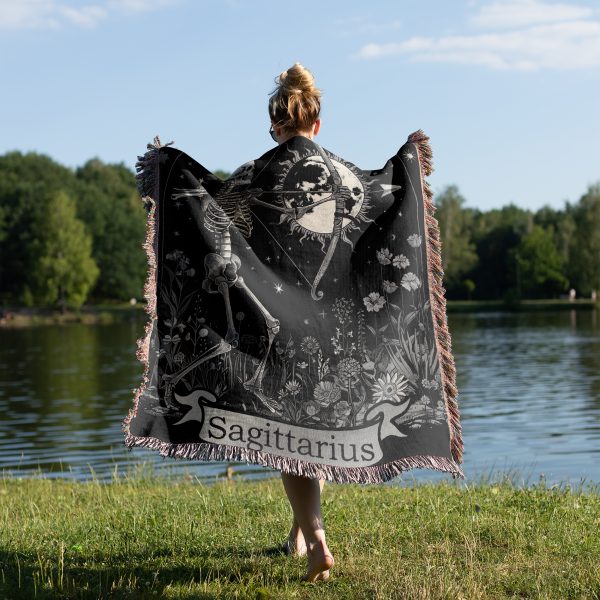 Woman wrapped in Sagittarius Archer woven blanket, archer design visible from behind.