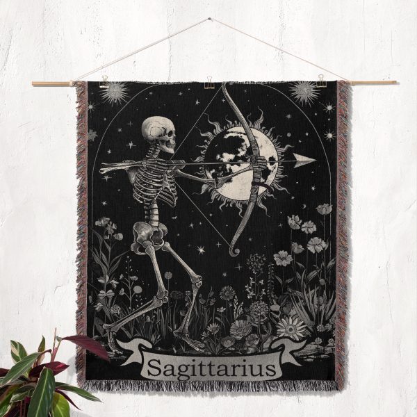 Sagittarius Archer woven blanket hung on wall as tapestry, showcasing skeleton archer and floral details.