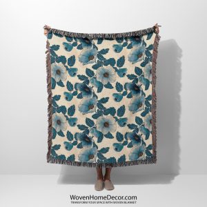 Floral woven blanket held by woman, showcasing delicate flower patterns in soft, romantic colors.