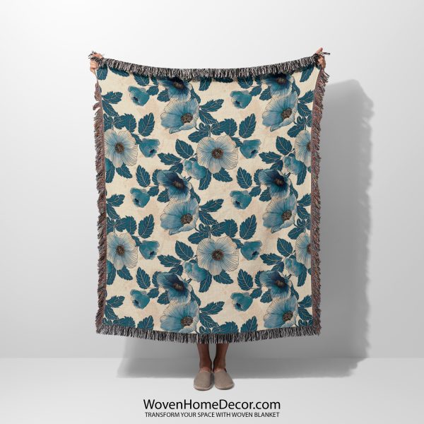 Floral woven blanket held by woman, showcasing delicate flower patterns in soft, romantic colors.