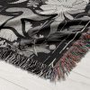 Close-up of Scorpio Mystery woven blanket, highlighting detailed scorpion and night sky.