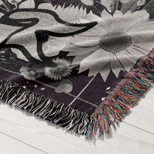 Close-up of Taurus Earth woven blanket, highlighting intricate calf skull and floral details.