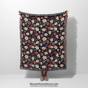 Floral woven blanket held by woman, featuring bright, bold flowers in a rainbow of colors.