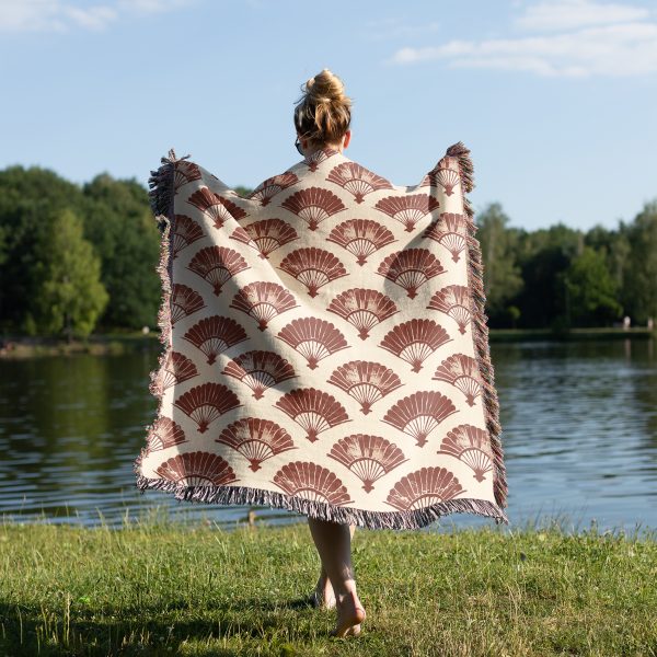 Woman wrapping herself in Japanese style woven blanket, back view, cozy and warm design.