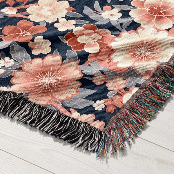 Close-up of floral woven blanket, showcasing intricate flower designs in a palette of soft pastels.