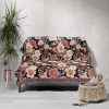 Floral woven blanket draped over couch, bringing fresh, bright flower patterns and soft colors into the room.