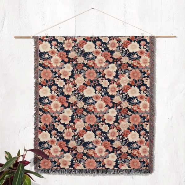 Floral woven blanket hanging on wall as tapestry, showcasing beautiful flower patterns in pastel hues.