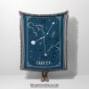 A person holding a Cancer zodiac woven blanket, featuring a detailed crab constellation design with soft blues and delicate celestial accents.