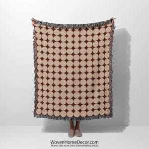 Person holding the Modern Dot Grid Woven Blanket with beige dots arranged on a rich brown background.