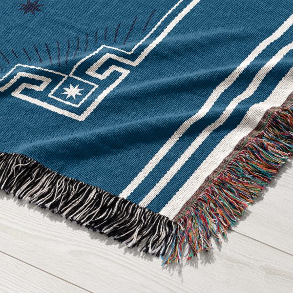 A close-up of the Pisces zodiac woven blanket, displaying the twin fish constellation with fluid, graceful lines and calming blue and turquoise colors.