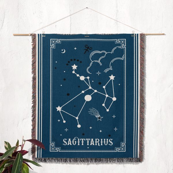 The Sagittarius zodiac woven blanket hanging as a tapestry, with the archer constellation and rich purple and gold colors adding a cosmic touch to the room.