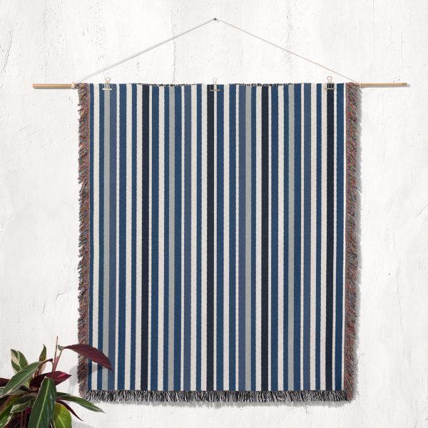 The Scandinavian Striped Woven Blanket hung as wall decor, showcasing its clean lines.