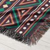 Detailed view of the African-patterned woven blanket, highlighting its vibrant patterns.