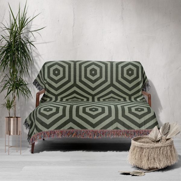 Sofa covered with a modern hexagonal woven blanket, adding a stylish touch to the living room.