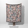 Main photo of the Scandinavian Chevron Harmony Woven Blanket held by a person, person not visible.