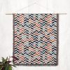 Scandinavian Chevron Harmony Woven Blanket displayed on a wall as a tapestry.