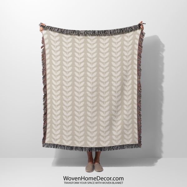 Main photo of the Scandinavian Minimalist Leaf Woven Blanket held by a person, person not visible.