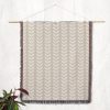 Scandinavian Minimalist Leaf Woven Blanket displayed on a wall as a tapestry.