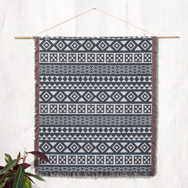 Scandinavian Tribal Stripe Woven Blanket displayed on a wall as a tapestry.