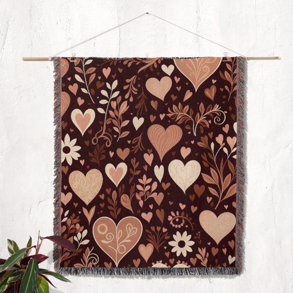 The Floral and Heart Dark blanket displayed on a wall as a tapestry