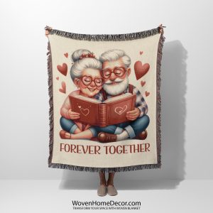 A woven blanket depicting an elderly couple reading together, held up by a person.