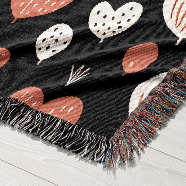 A close-up of the woven texture and vibrant heart patterns of the Heart Pattern Woven Blanket.