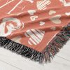 A close-up of the vibrant symbols and rich texture of the Love Symbols Woven Blanket.