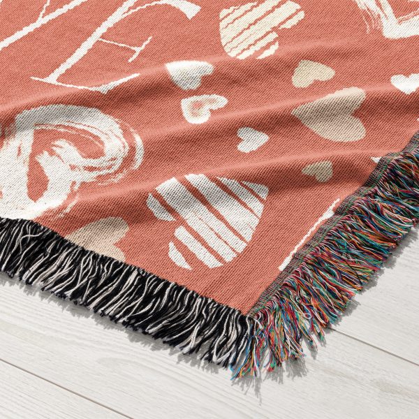 A close-up of the vibrant symbols and rich texture of the Love Symbols Woven Blanket.